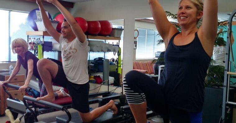 3 people using the Pilates reformer